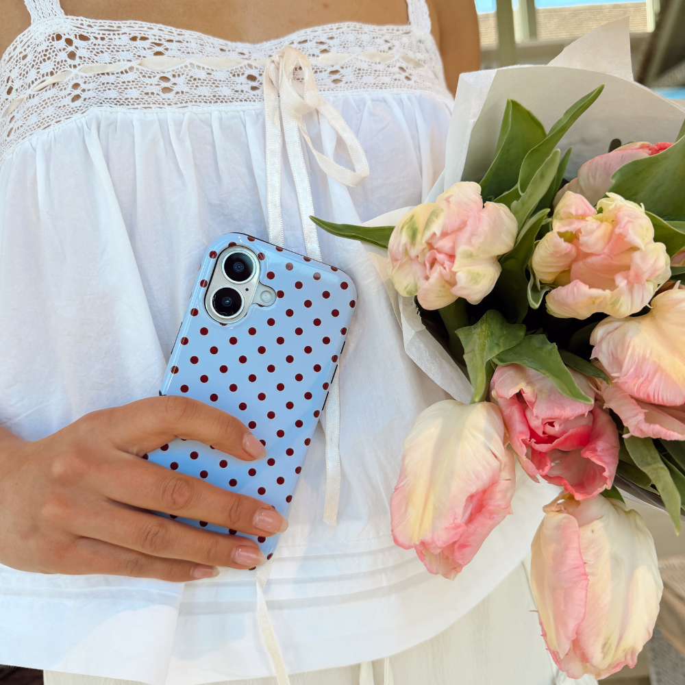 Girl holding flowers with the Blue and Brown Polka Dot Phone Case