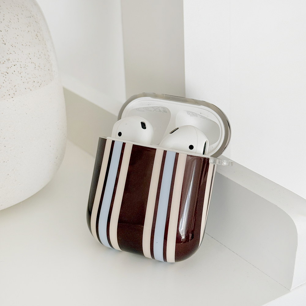 Showing the inside of brown, white and blue striped AirPods Case.