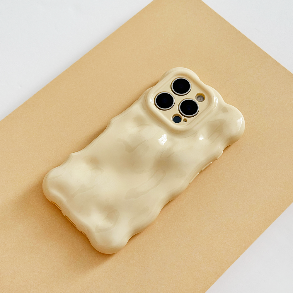 Butter yellow 3D bubble phone case by Coconut Lane on a beige smartphone, shown from above on a tan background.