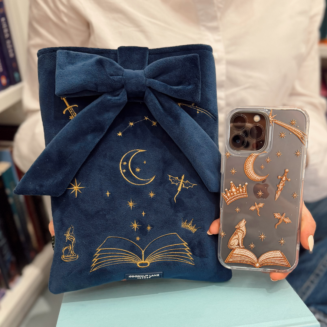 Clear fantasy girl phone case with golden illustrations of fantasy themed beaded effect icons, such as a book, wolf, crown, moon, sword, stars and dragons.
Image includes the matching velvet material book sleeve with matching design.