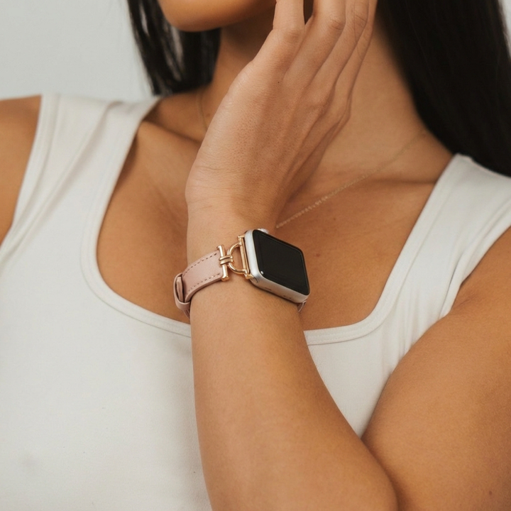 Woman in a white sleeveless top wearing a pink Vegan PU leather Apple Watch strap from Coconut Lane.