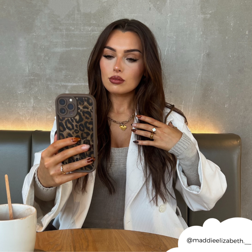 Girl taking a selfie with mocha leopard phone case