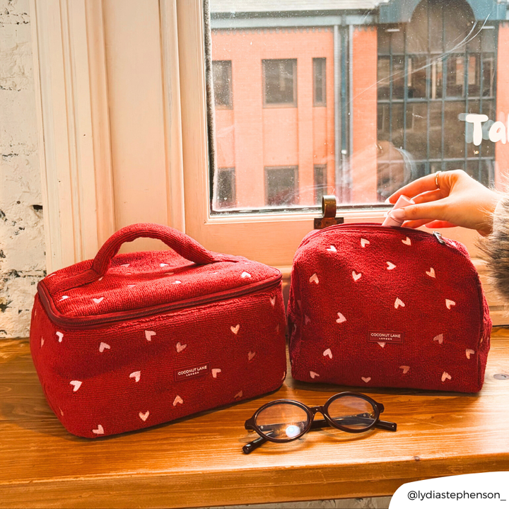 Mulberry Hearts Towel Makeup Bag and Vanity Case next to each other on a window