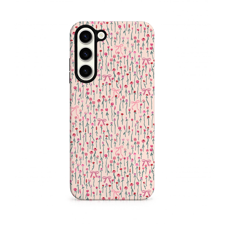 Phone case with a pink peony and bow design on a white background