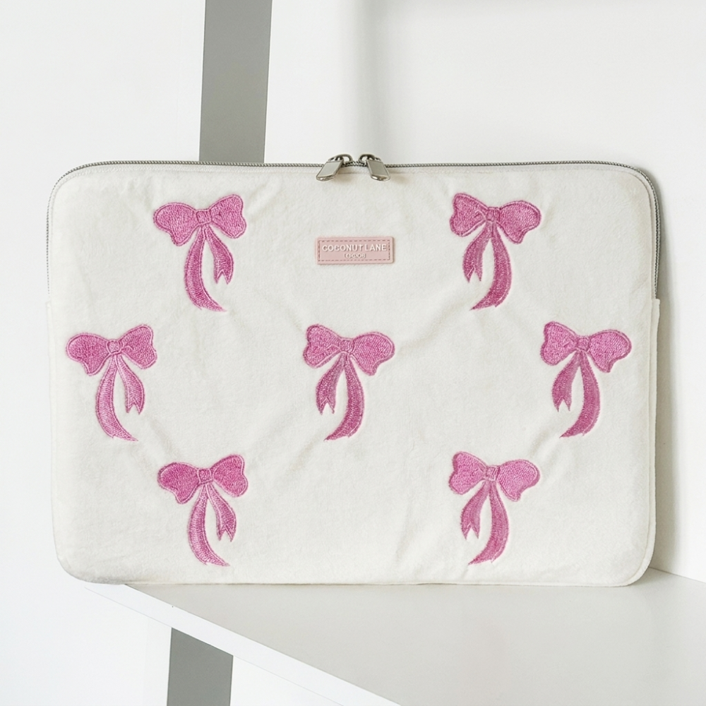 White soft velvet Laptop Sleeve with zip closure and Coconut Lane logo. Embroidered with pink bows.