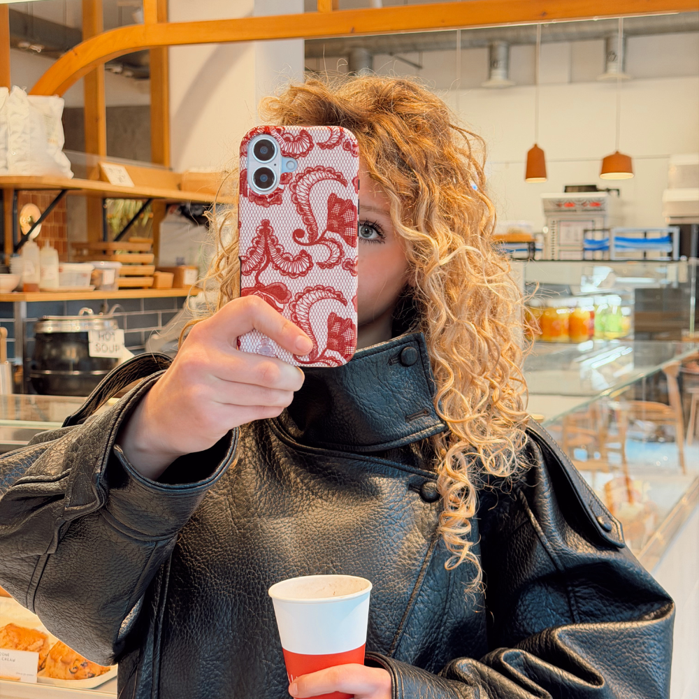 Girl in cafe ordering coffee taking selfie with red lace tough phone case