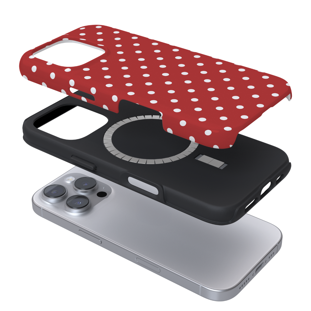 A three-layer exploded view of a phone case set: a red case with white polka dots on top, a black protective layer in the middle, and a silver smartphone underneath on a white background.