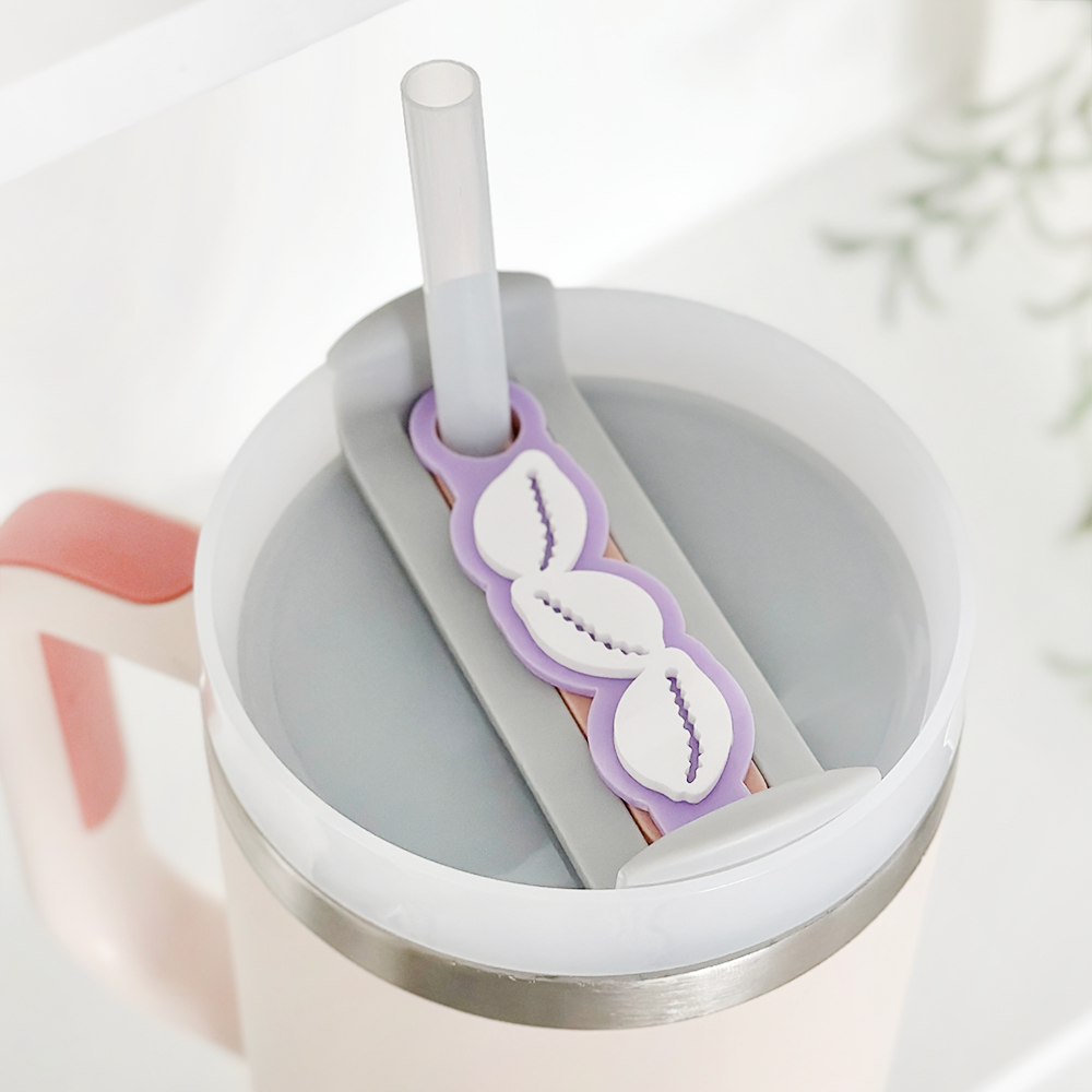 Lilac shell-shaped tumbler topper from Coconut Lane, designed to fit over a straw and lid.