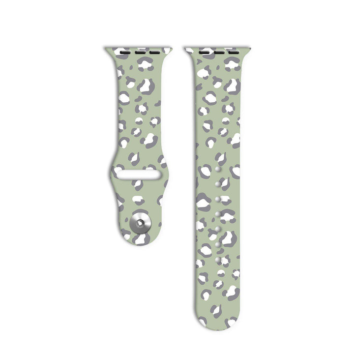 Two pieces of the Sage Leopard Apple Watch Strap by Coconut Lane are displayed against a white background. The strap features a light green base color with a gray and white leopard print pattern, reflecting its unique style from the Sage Leopard Collection.