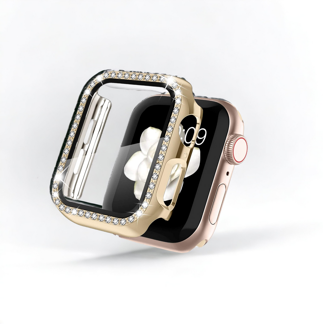 A gold Apple Watch with a rectangular screen is displayed. The watch features a luxurious Coconut Lane 2-in-1 Apple Watch Case & Built-In Screen Protector - Gold Diamante, which partially covers the screen with its sparkling, diamond-encrusted design. The crown button and a portion of the digital display showing the time are visible. The background is plain white.