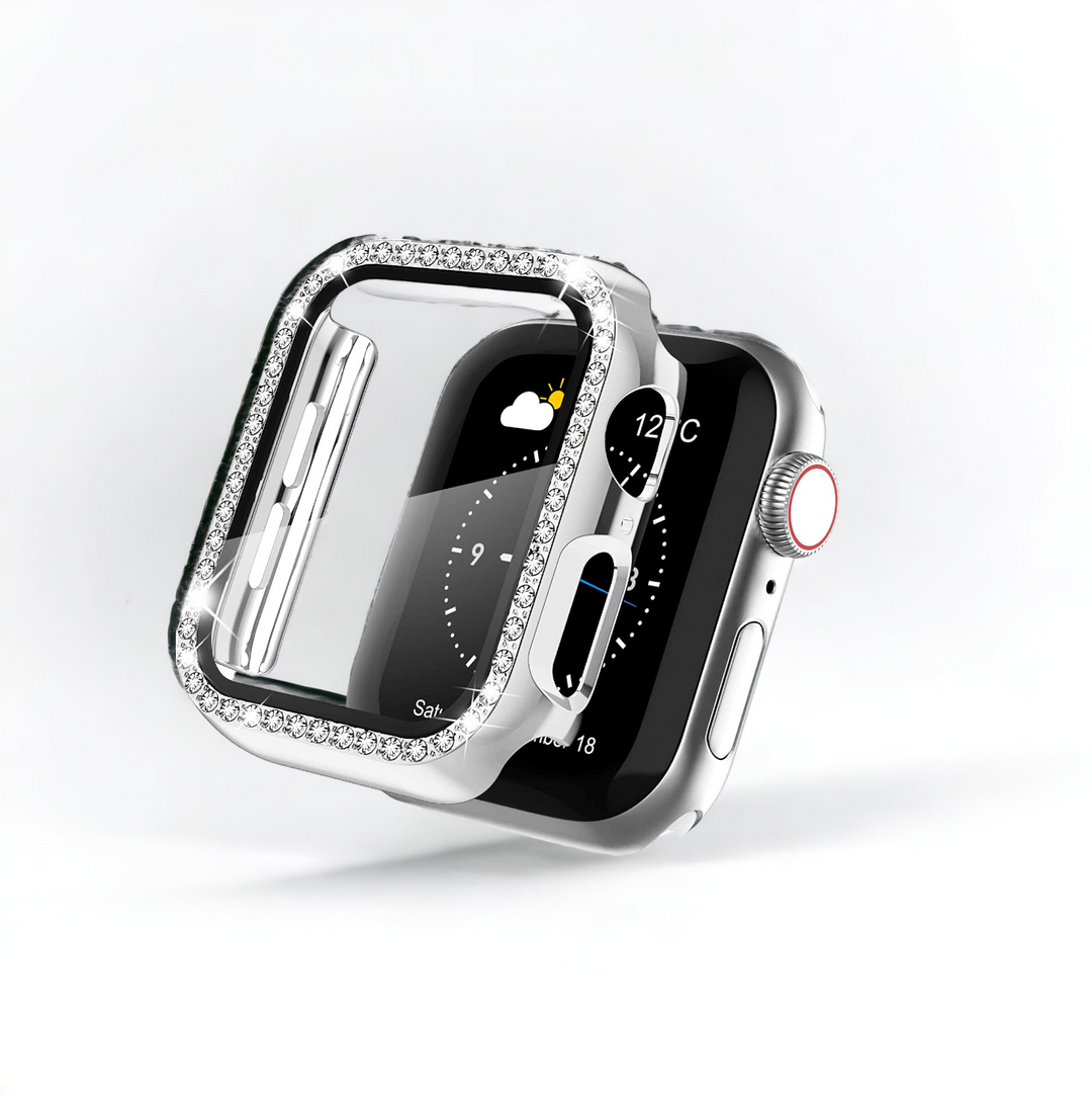 A close-up of a silver Apple Watch with a rectangular screen displaying weather information, partially covered by Coconut Lane's 2-in-1 Apple Watch Case & Built-In Screen Protector - Silver Diamante. The shock-proof, transparent case is adorned with small, shiny crystals along the edges. The background is plain white.